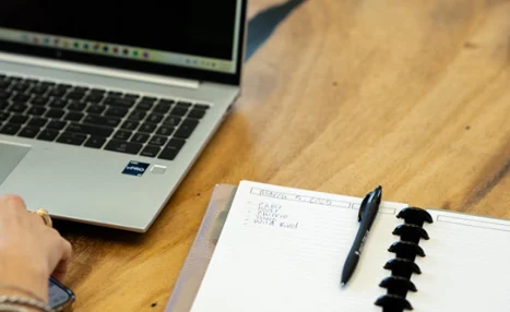 Laptop and notebook on a desk